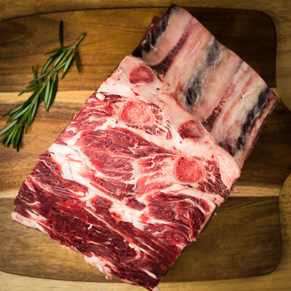 Butcher carefully preparing fresh cuts of meat